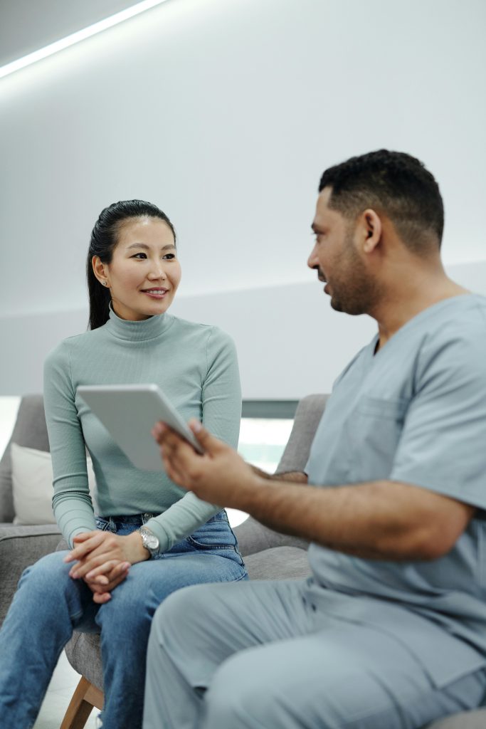 Healthcare professional and patient discussing treatment options in a modern clinic setting.